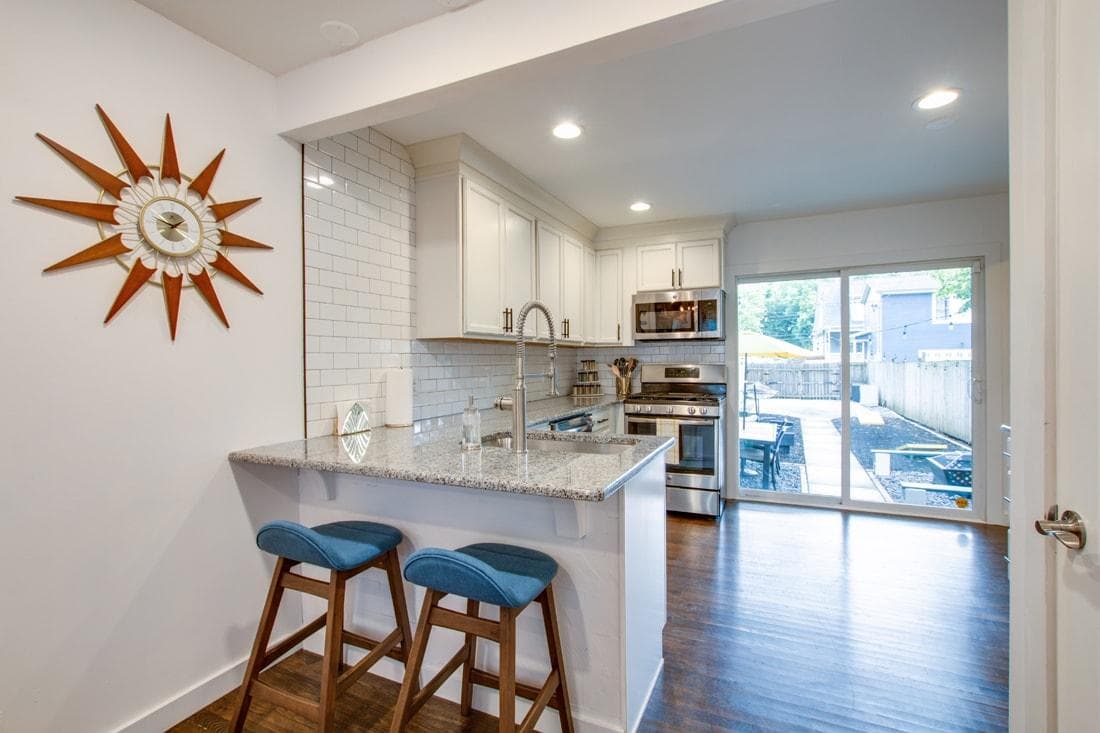 Bright fully equipped kitchen with lots of natural light leading out to patio